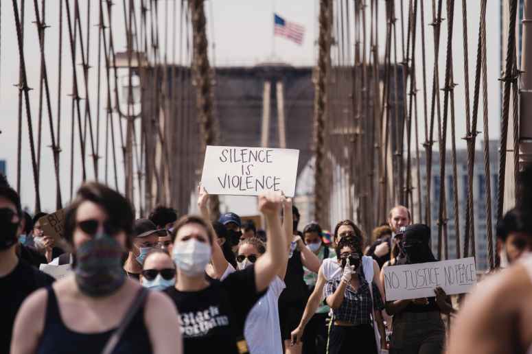 crowd of protesters holding signs